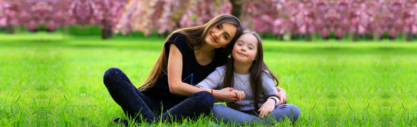 adult woman and little girl smiling